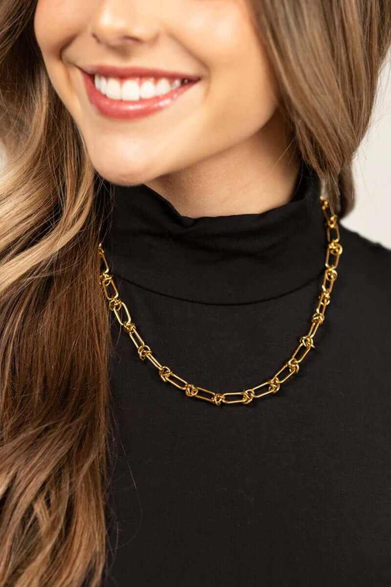 18k gold plated stainless steel barbed wire necklace on woman wearing black top