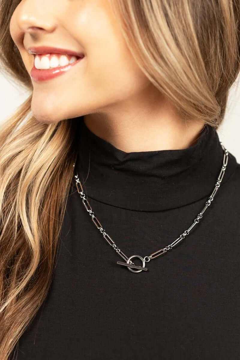 Close-up of a woman wearing an 18K stainless steel toggle chain necklace with a sleek design.