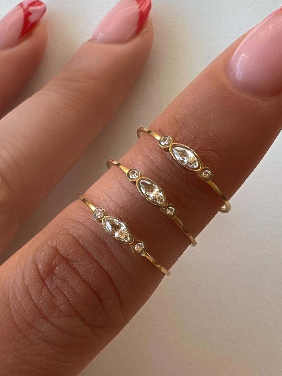 Delicate candy-colored pearl gold plated statement rings on fingers