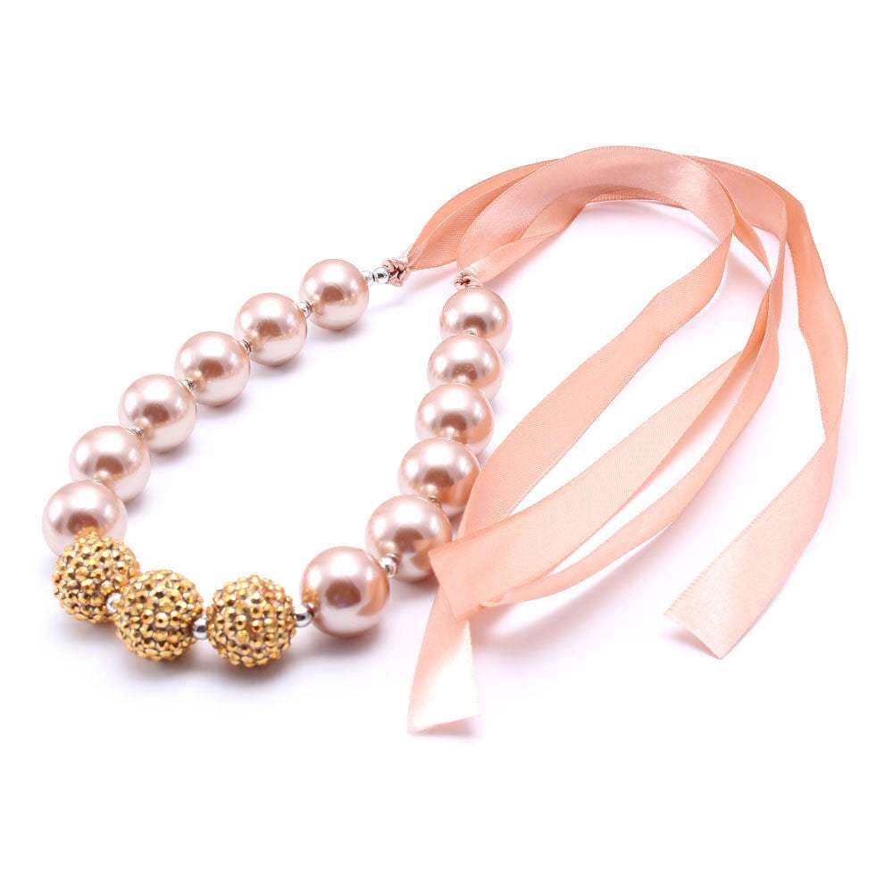 European style children's pearl necklace with pink ribbon and gold bead accents