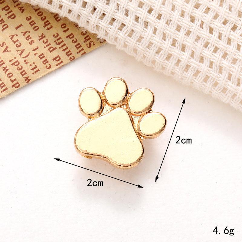 Gold paw print ornament measuring 2cm, perfect for embellishing shoes or accessories with a cute animal theme.