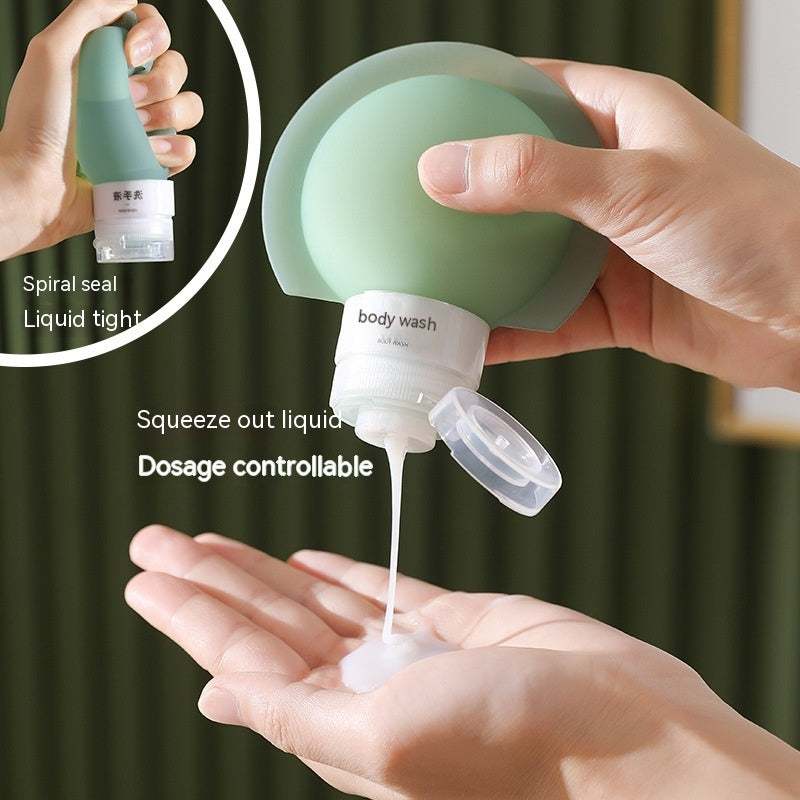 Refillable travel bottle squeezing body wash from green silicone bottle with spiral seal and liquid-tight cap