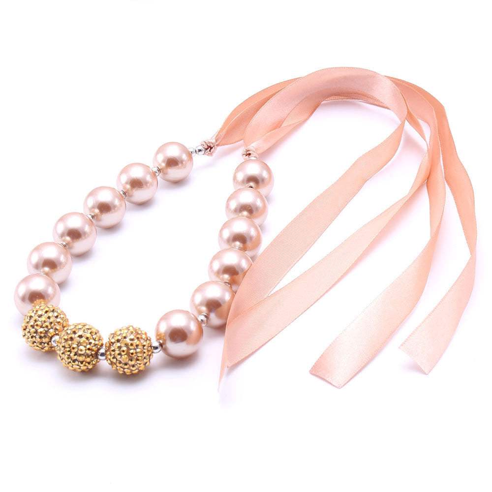 European style children's pearl necklace with pink ribbon and gold bead accents