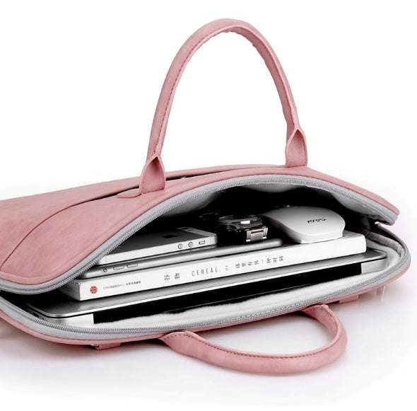 Faux leather laptop bag for women, showcasing a pink synthetic leather design with a zipper opening.
