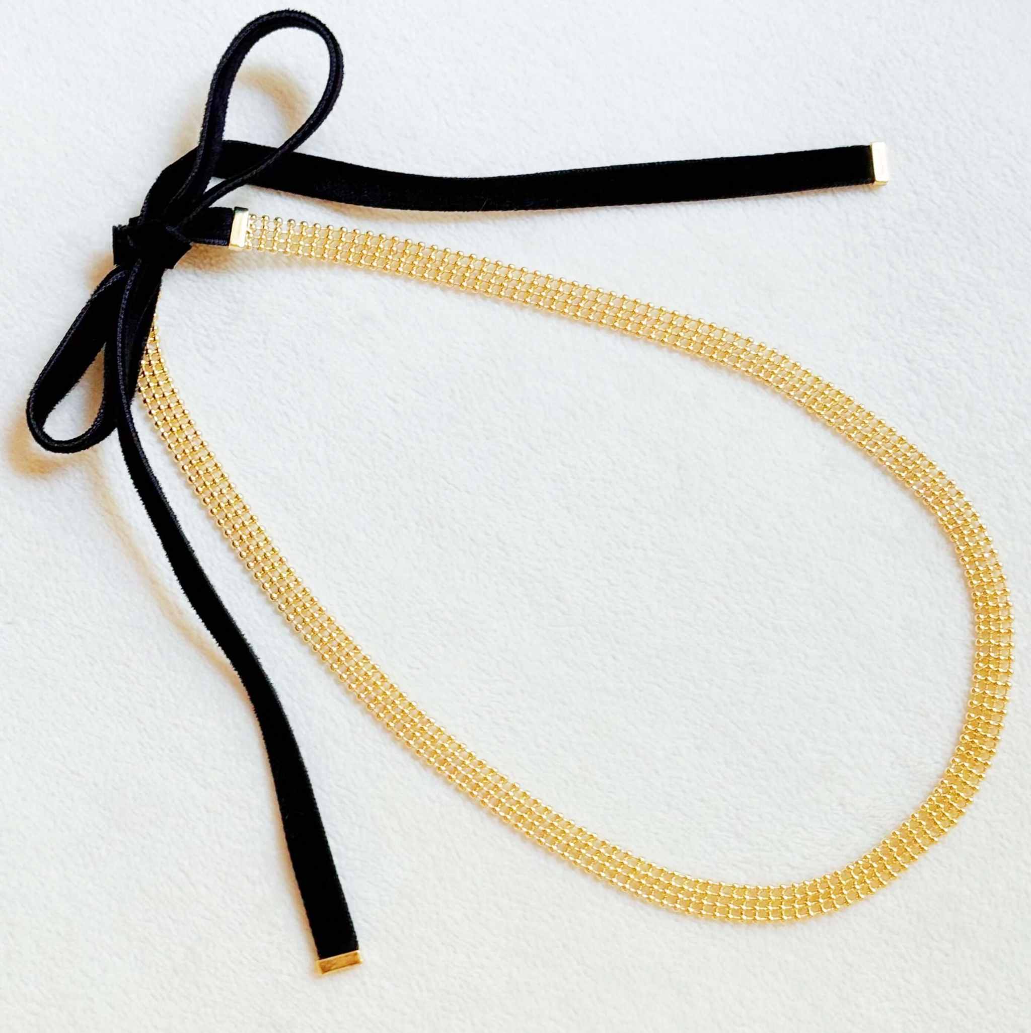 Adjustable gold tie back choker necklace with velvet sash ties, perfect for versatile styling and elegant looks.