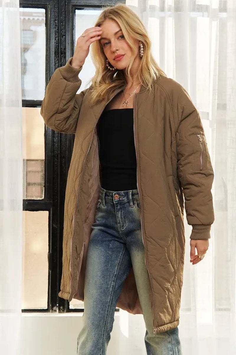 woman wearing brown zip up long utility jacket with pockets and black top indoors