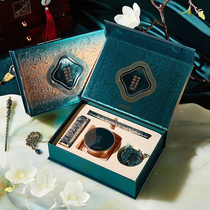 Luxurious ornate green Air Cushion & Lipstick all-in-one makeup kit with cream cushion, liquid eyeliner, velvet matte lipstick, and powder puff in decorative box