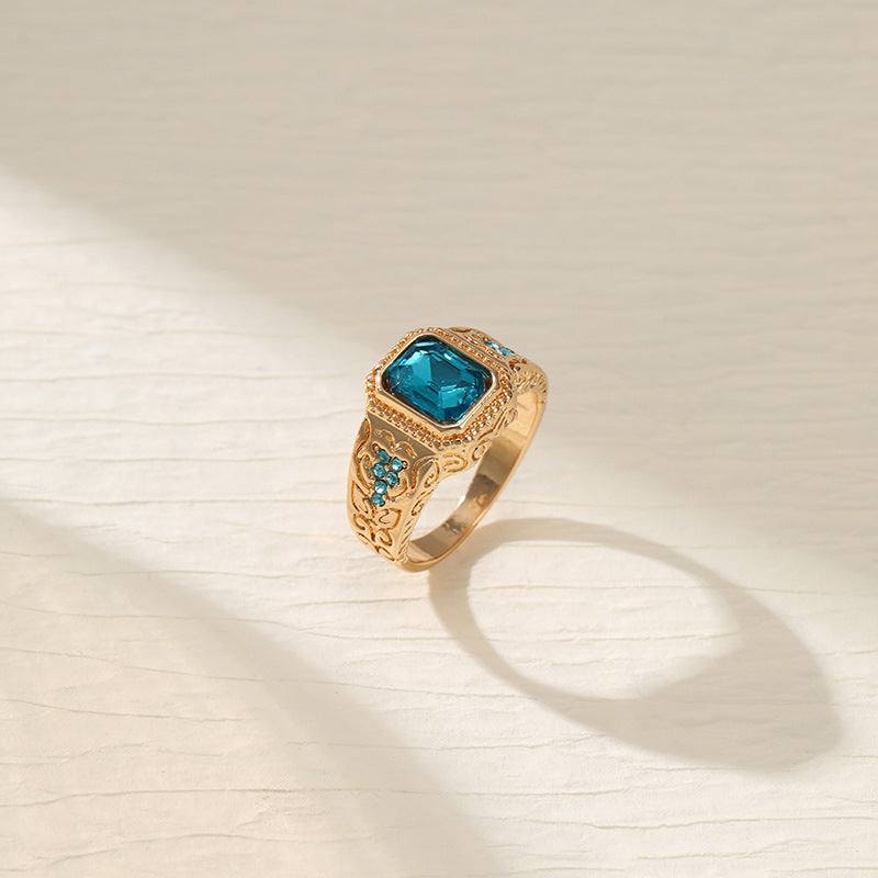 Gold alloy plating ring with square ice blue rhinestone and geometric design