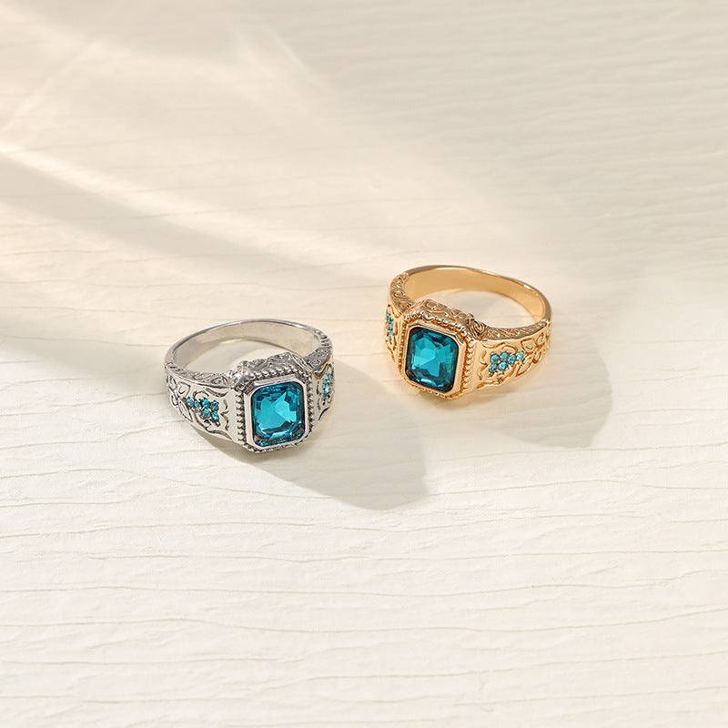Alloy plating couple rings with ice blue rhinestone and geometric design in gold and silver colors
