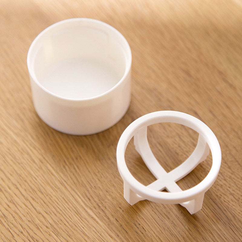 White plastic Beauty Egg Stand cosmetics storage rack on wooden surface