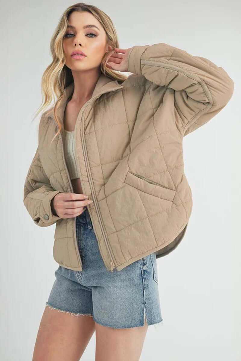Stylish Bebe puffer jacket in beige, featuring oversized design, zip closure, and perfect for all-season layering.