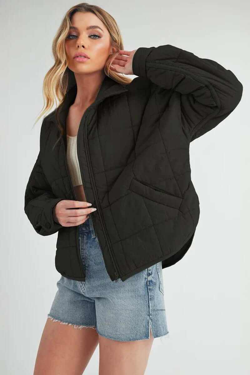 Stylish woman wearing a black Bebe puffer jacket with an oversized fit, perfect for winter fashion.