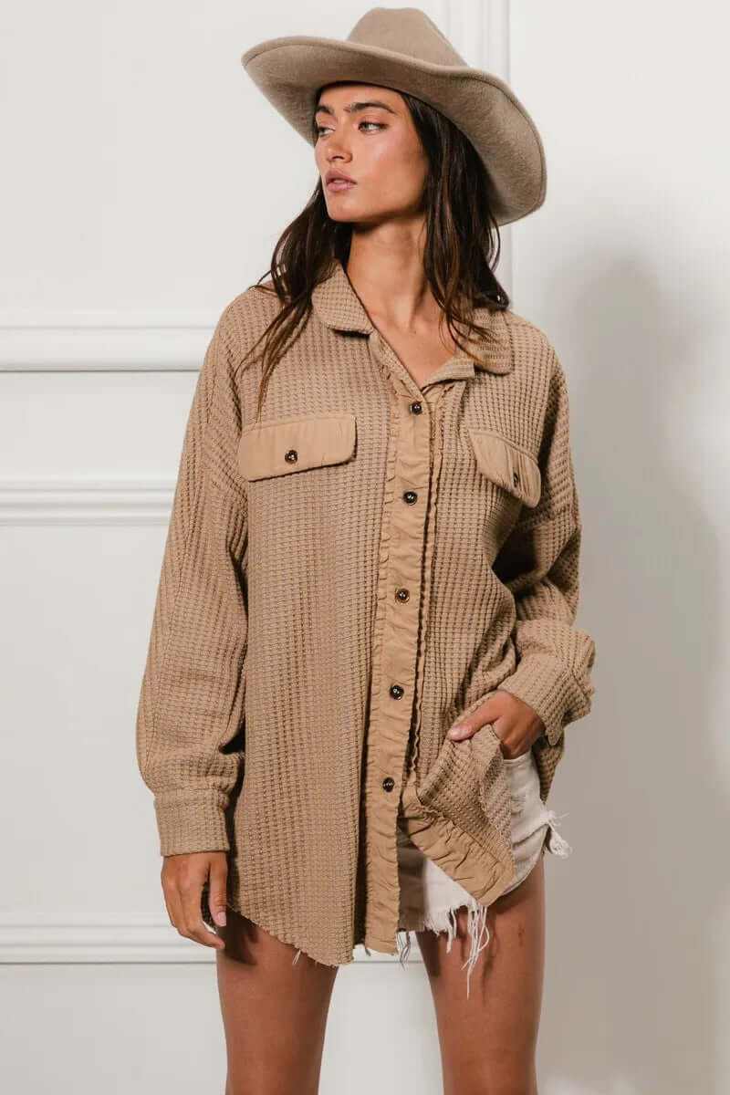 Model wearing a beige heavy waffle oversized shacket styled with a hat and shorts, perfect for casual layering.