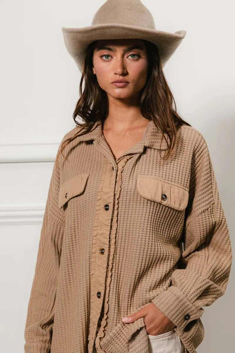 Model wearing a Bibi Heavy Waffle Oversized Shacket in beige with a hat, showcasing a cozy layered outfit.