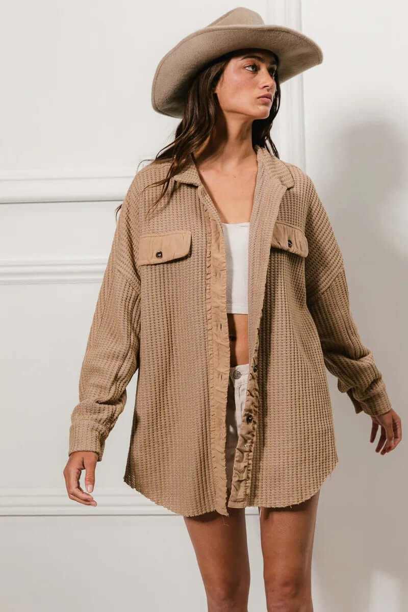 Woman wearing Bibi Heavy Waffle Oversized Shacket with buttoned front, paired with a stylish hat, showcasing a trendy layered look.