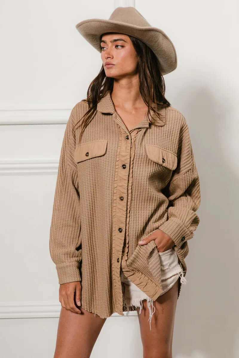 Woman wearing a beige heavy waffle oversized shacket with button front and two pockets, styled for a casual look.