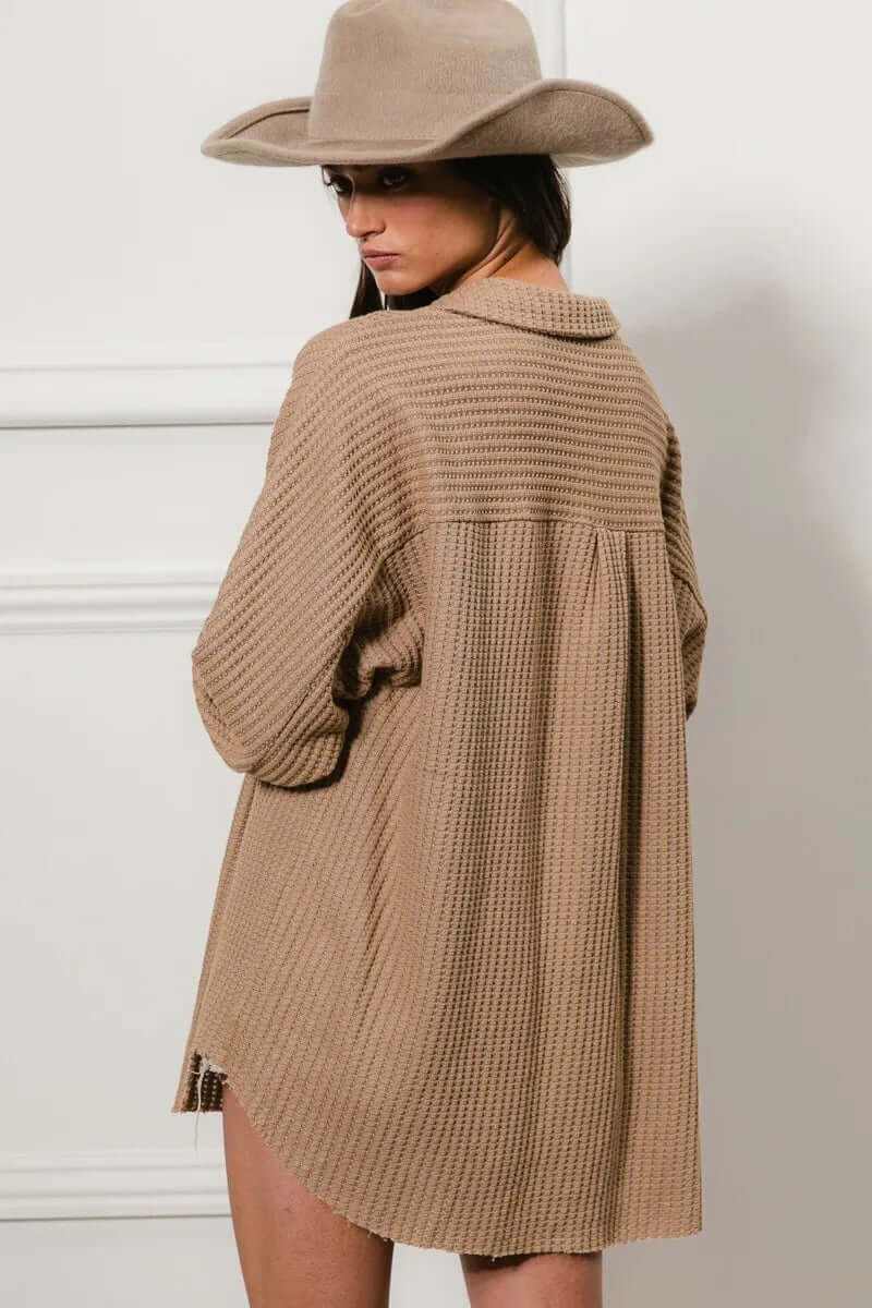 Model wearing a beige heavy waffle oversized shacket with a hat, showcasing its cozy texture and relaxed fit.