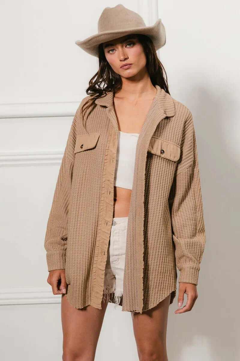 Model wearing Bibi Heavy Waffle Oversized Shacket in beige, styled with shorts and a hat for a casual look.