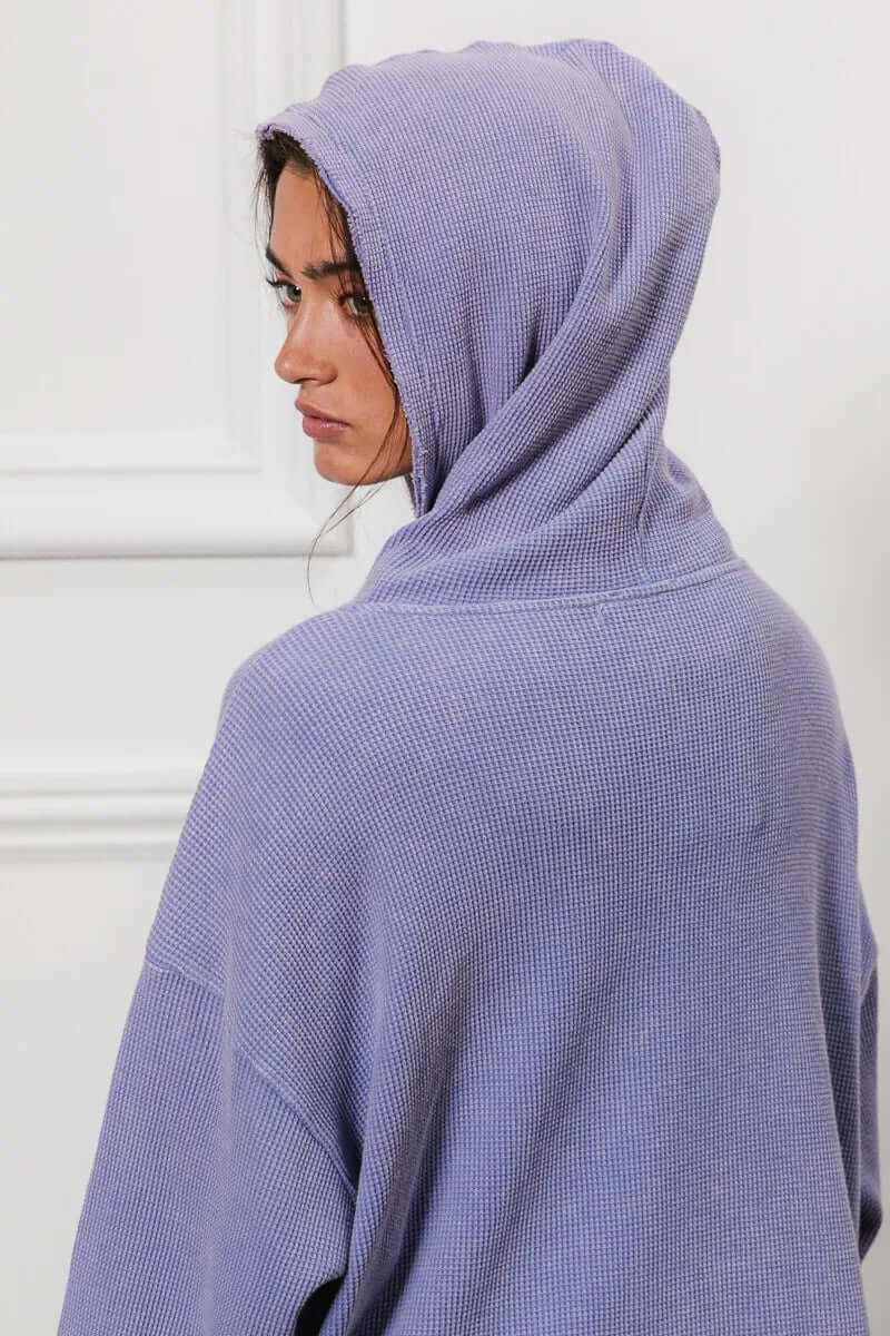 Model wearing a Bibi washed waffle thermal hooded jacket in purple, showcasing the relaxed oversized fit and cozy design.