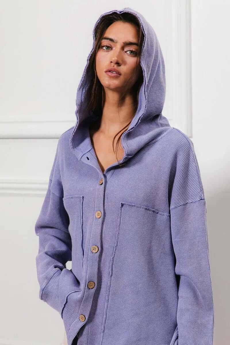 Model wearing a Bibi washed waffle thermal hooded jacket in purple, showcasing its oversized fit and buttoned design.