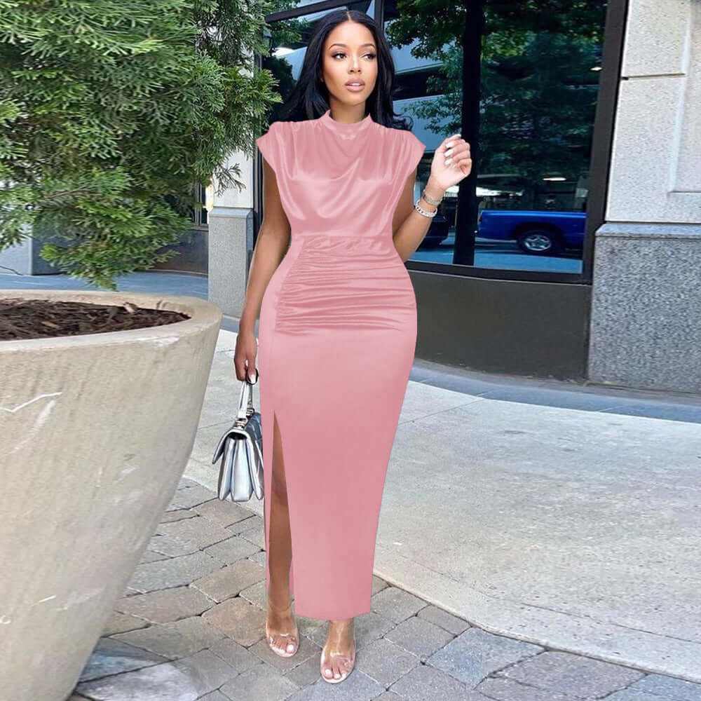 Fashionable plus-size woman wearing a pink solid color dress with a side slit, perfect for summer outings.