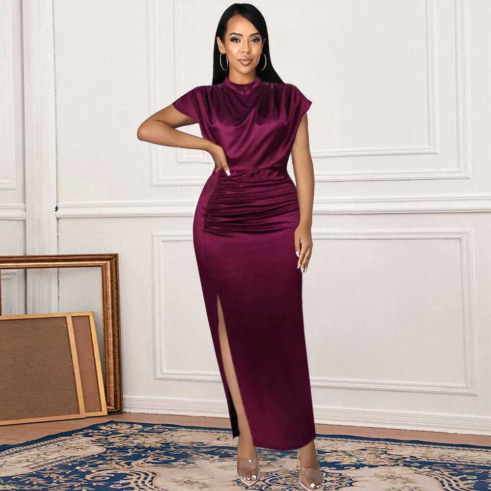 Woman in a burgundy silk maxi dress with side slit, showcasing a modern retro style, ideal for summer commutes.
