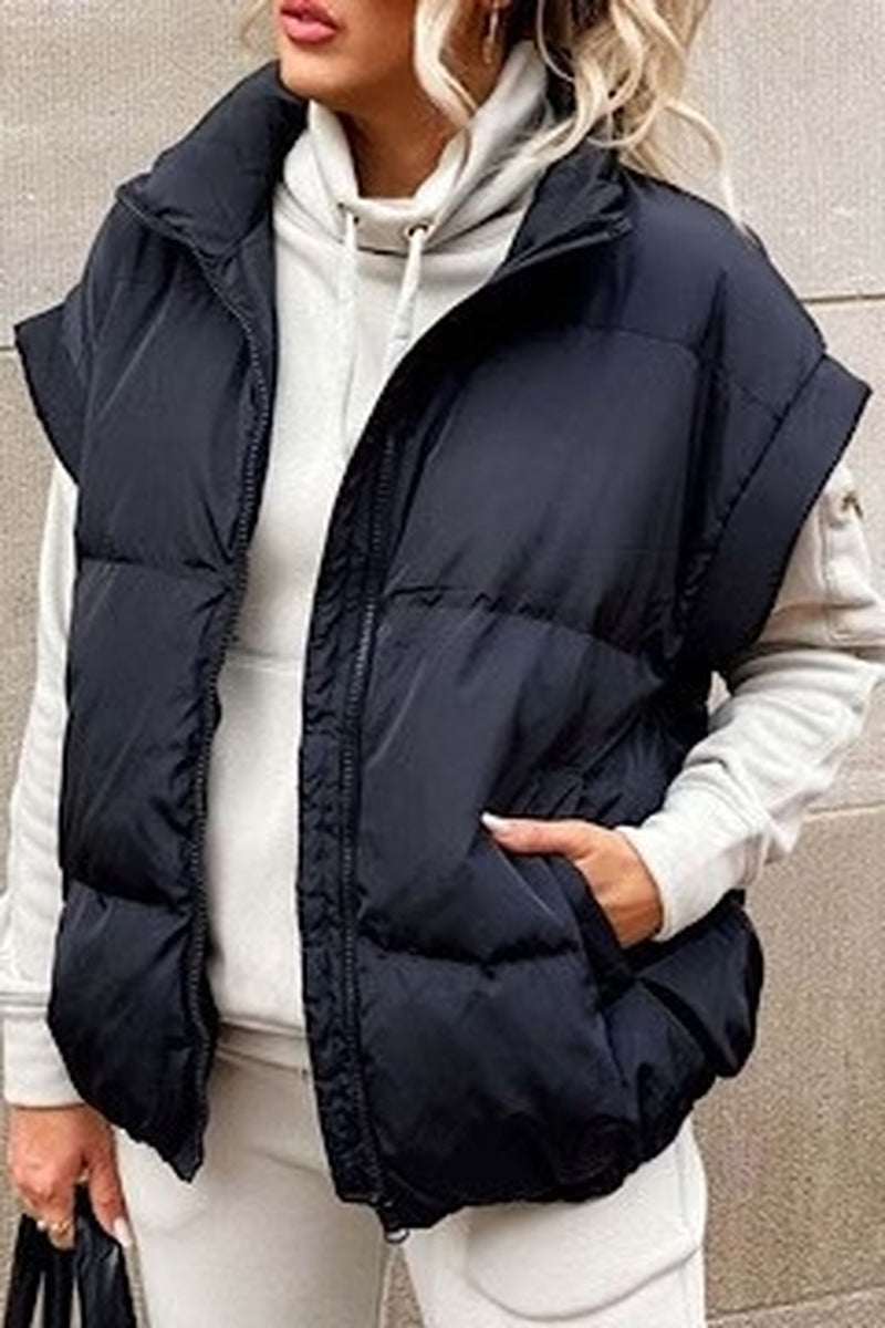 Stylish black puffer vest, perfect for layering, made in China, ideal for chilly weather and casual outfits.