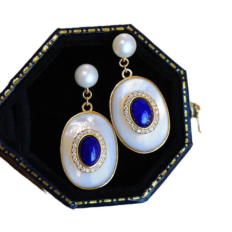 green egg noodles fritillary stud earrings with blue gem and pearl accents in black jewelry box