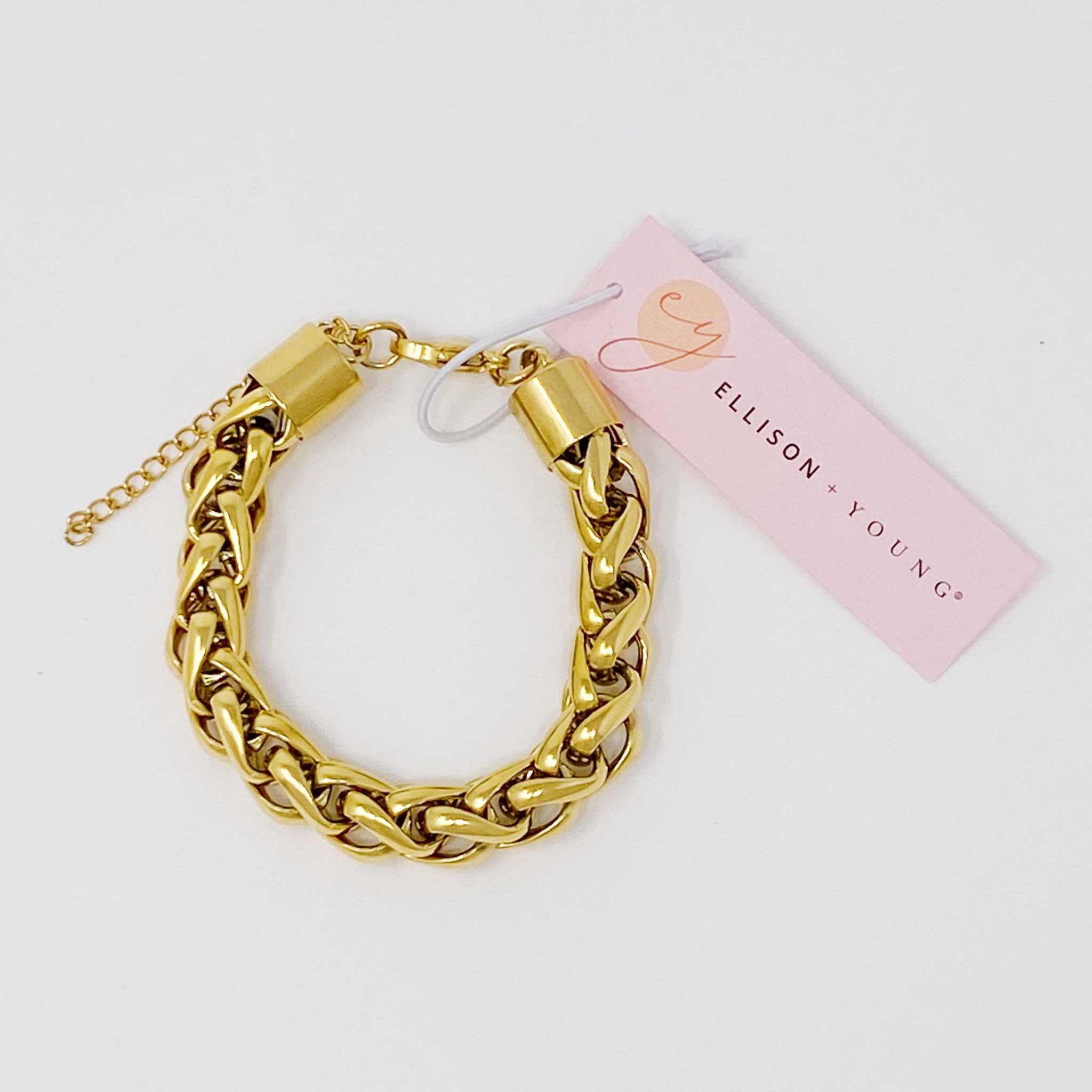 Bold and edgy gold chain bracelet with small links and extender, perfect for layering or as a statement piece.