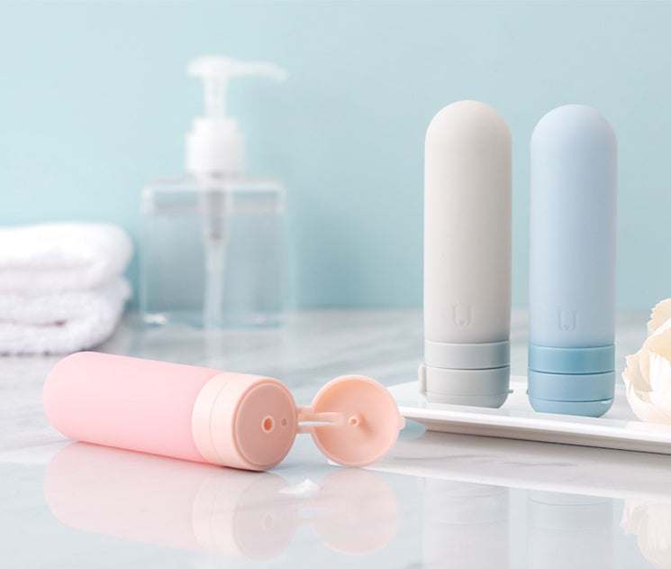 Set of pastel-colored silicone bottled travel cosmetics for easy storage and portability