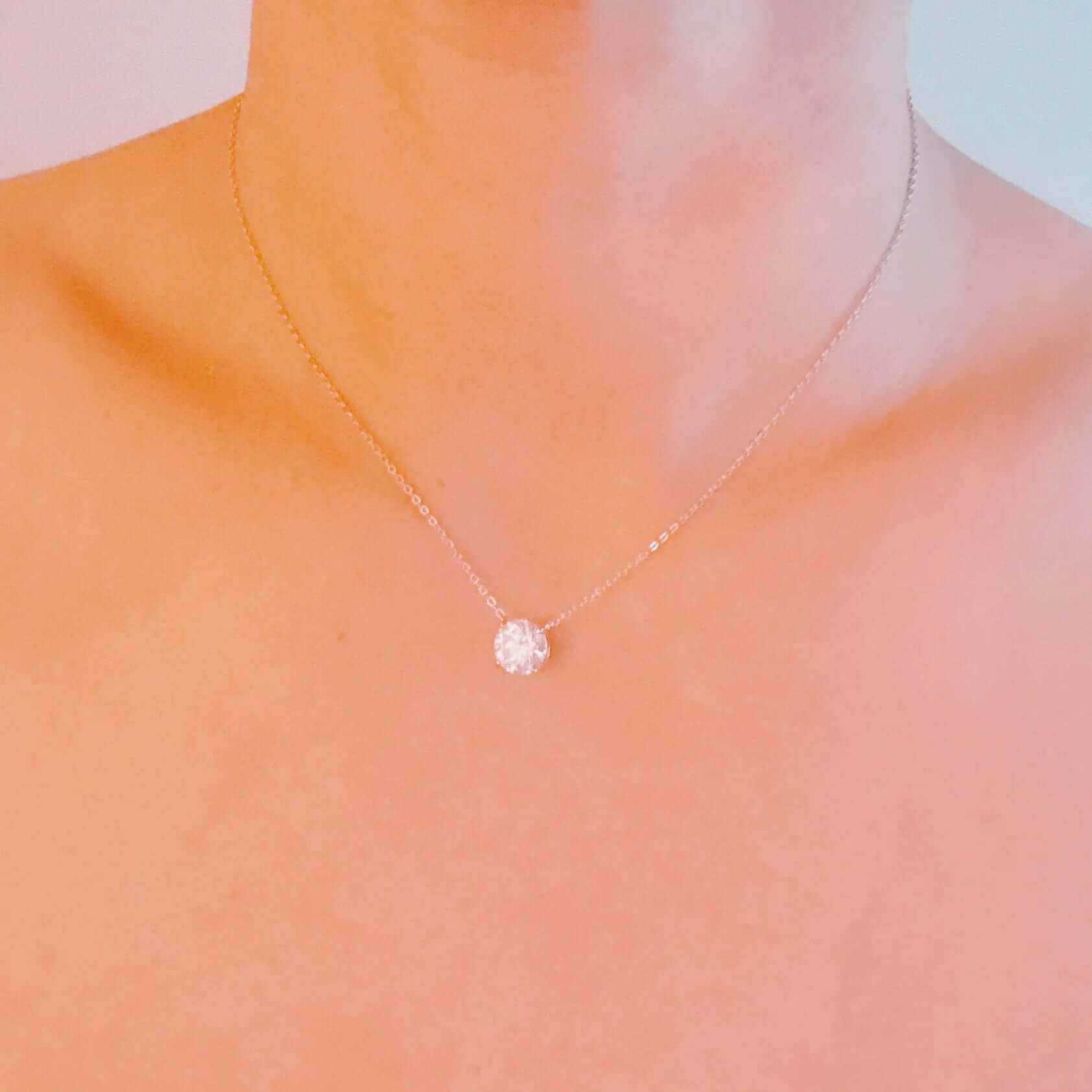 Brilliant Moissanite Floating Pendant Necklace on a model, showcasing its elegant design and sparkling centerpiece.