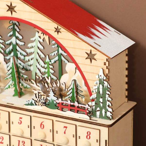 Wooden Christmas advent calendar with 24 drawers and festive village design with LED lights