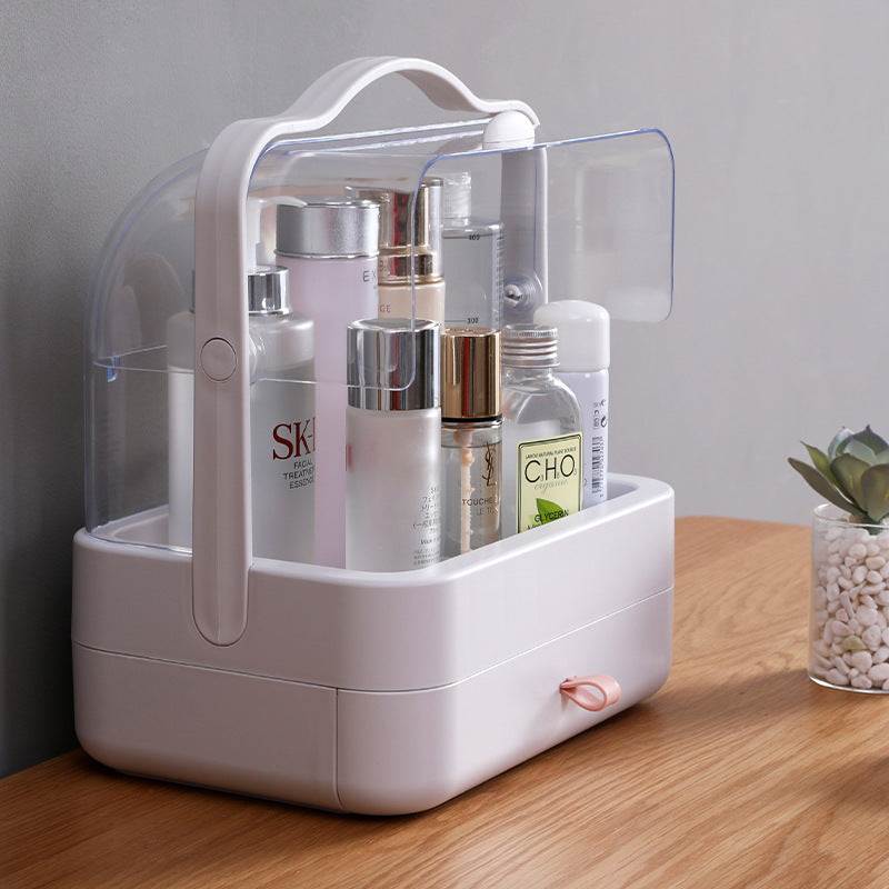 Clear and compact desktop makeup organizer with transparent cover and white base, storing skincare bottles.