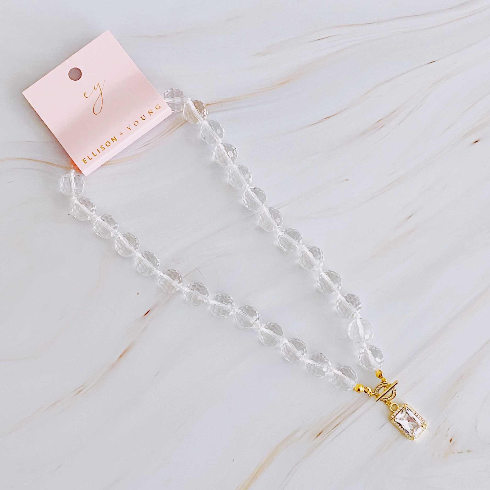 Clear crystal ball chain necklace with faceted glass beads and jeweled pendant, elegant accessory for any occasion.