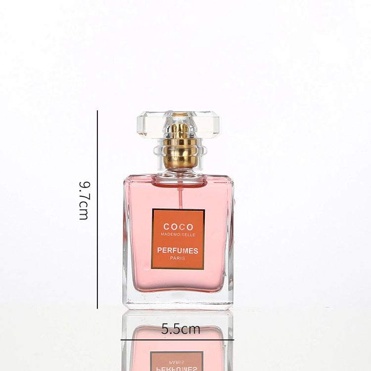 Clear square glass perfume bottle with pink liquid and gold spray nozzle measuring 9.7cm by 5.5cm