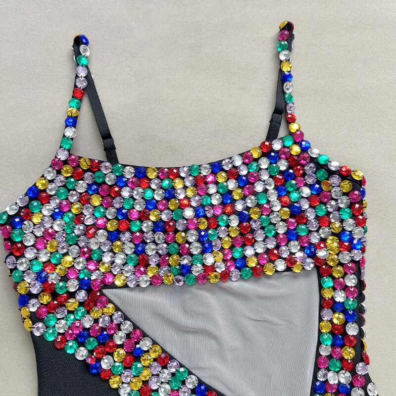 Colorful beaded design on a black womens dress, featuring vibrant gems for a stylish fashion statement.