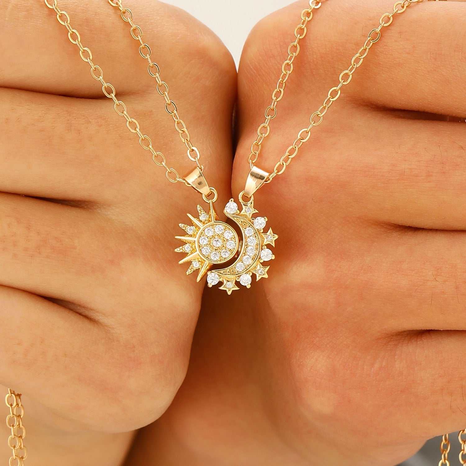 Gold couple set sun and moon necklaces with rhinestone details on chain