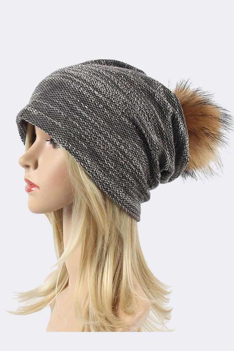 Cozy faux cotton blend slouchy beanie with faux fur pom on model's head, perfect for chilly days.