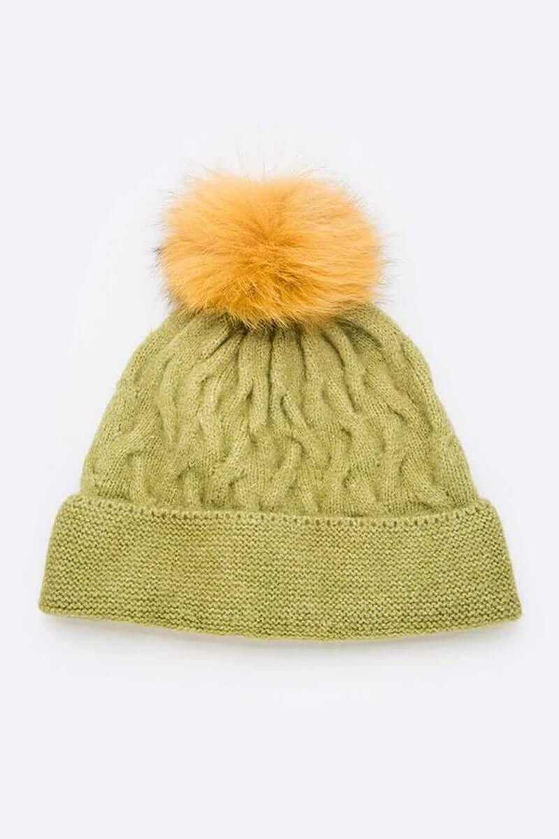 Cuffed slouchy beanie in olive green with a luxurious orange fur pom on top, perfect for stylish winter warmth.