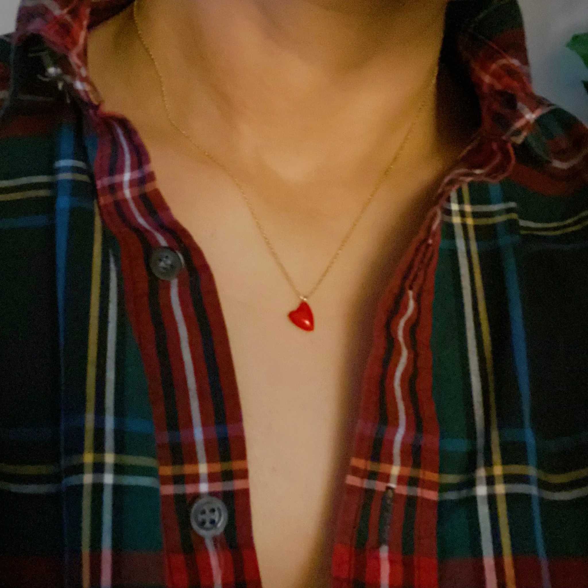 Cute colorful heart pendant necklace worn on a plaid shirt, ideal for casual layering and gifting.