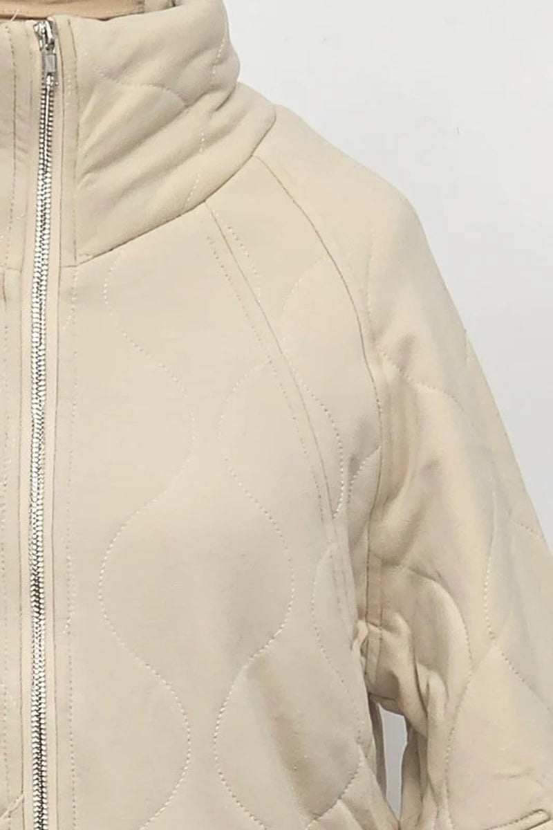 Darla Quilted Jacket in beige with quilted design, front zipper closure, and cozy oversized silhouette.