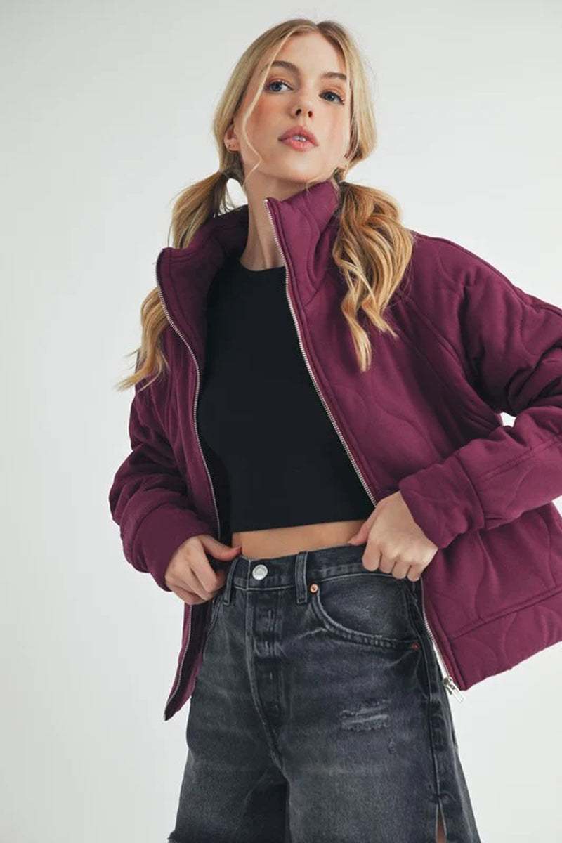 Darla Quilted Jacket in deep purple, showcasing its cozy oversized silhouette and stylish design, perfect for layering.