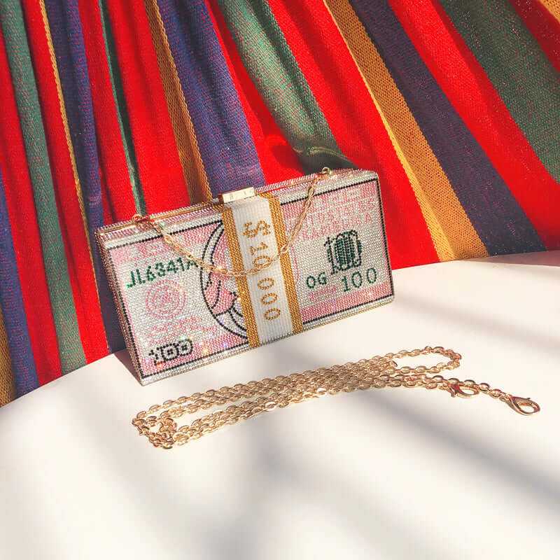 Diamond Crystal Dollar Women’s Luxury Clutch Purse with a gold chain against a colorful striped background.