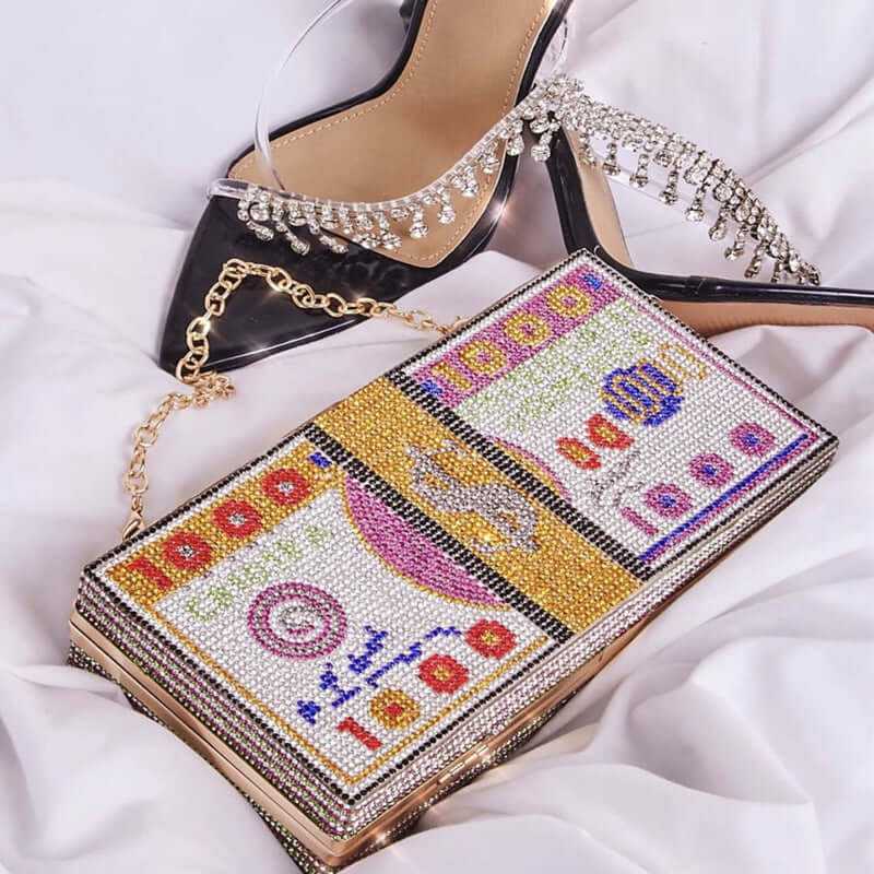 Diamond Crystal Dollar Women’s Luxury Clutch purse with rhinestone embellishments next to stylish high-heeled shoes.