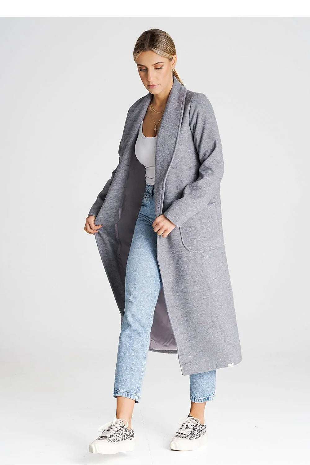 Elegant Figl Belted Trench Coat in gray, featuring long sleeves and large patch pockets, styled casually with jeans.