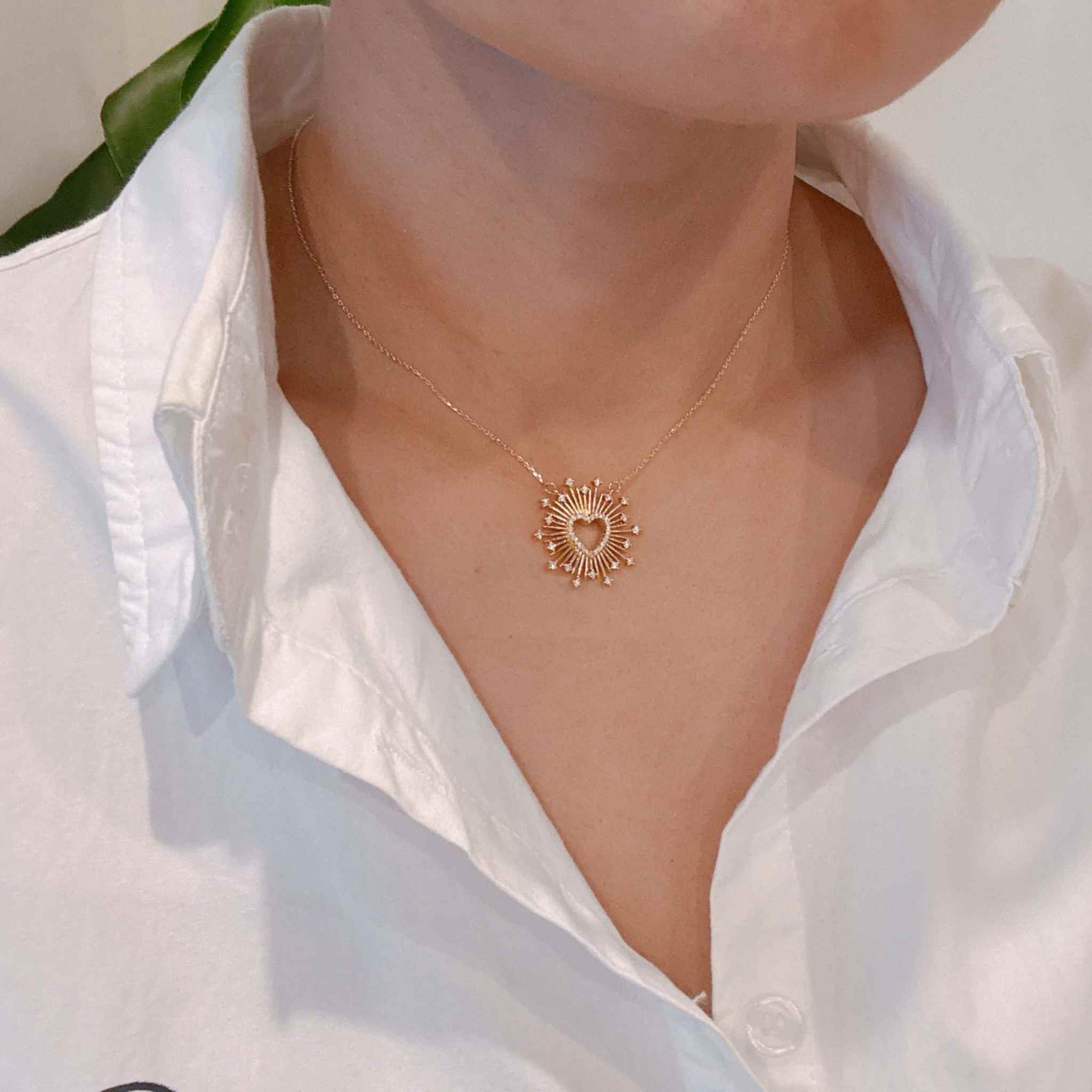 Elegant Heart of Shine pendant necklace worn on a person, showcasing its unique heart design and chic style.