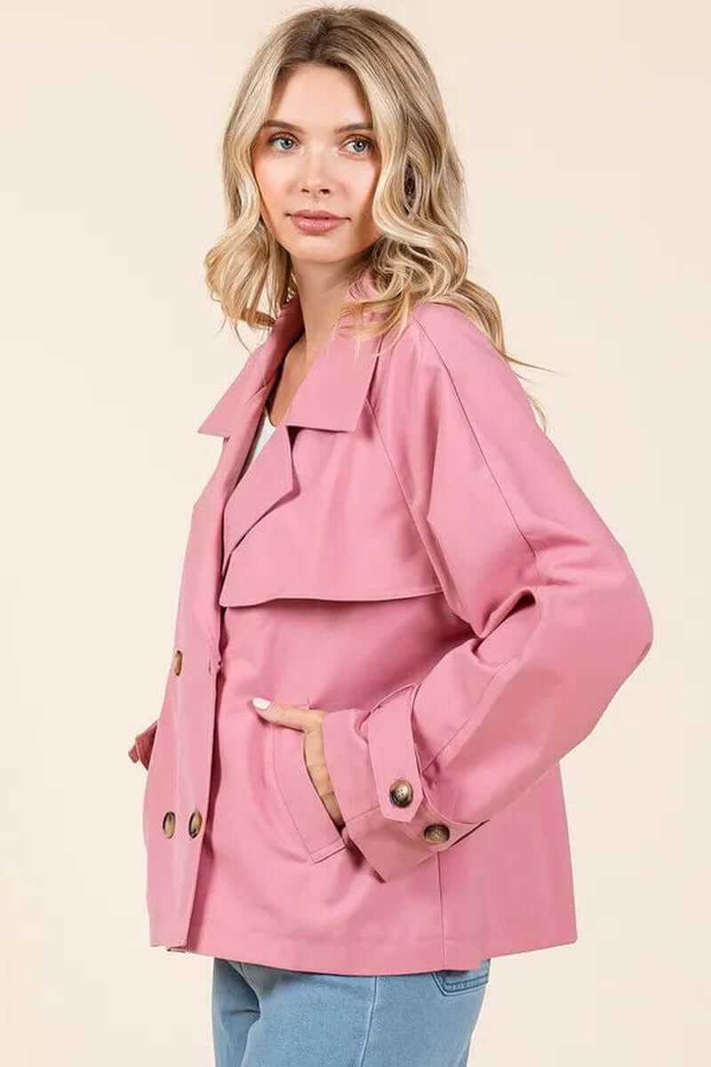 Elegant pink double-breasted trench coat jacket with long sleeves, designed for versatility and style.