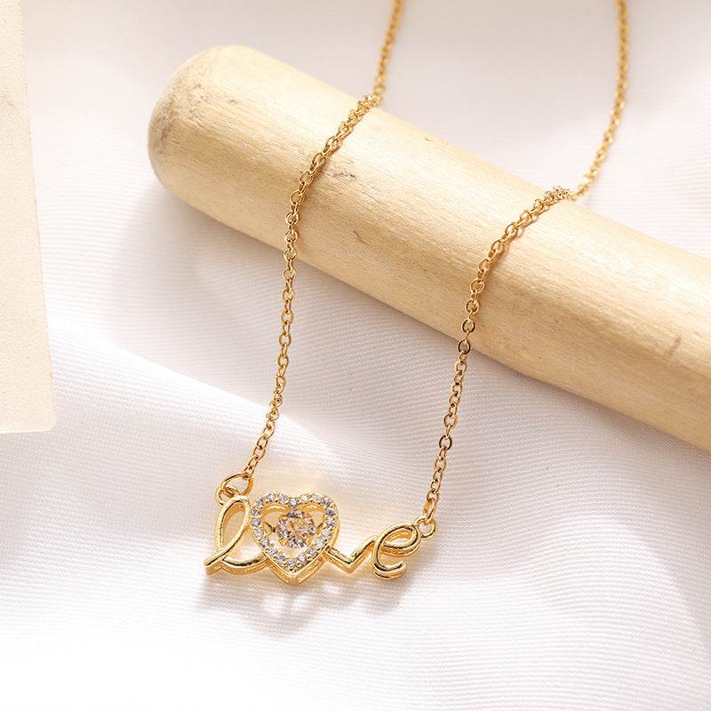 Gold fashion clavicle chain necklace with love heart pendant on wooden display