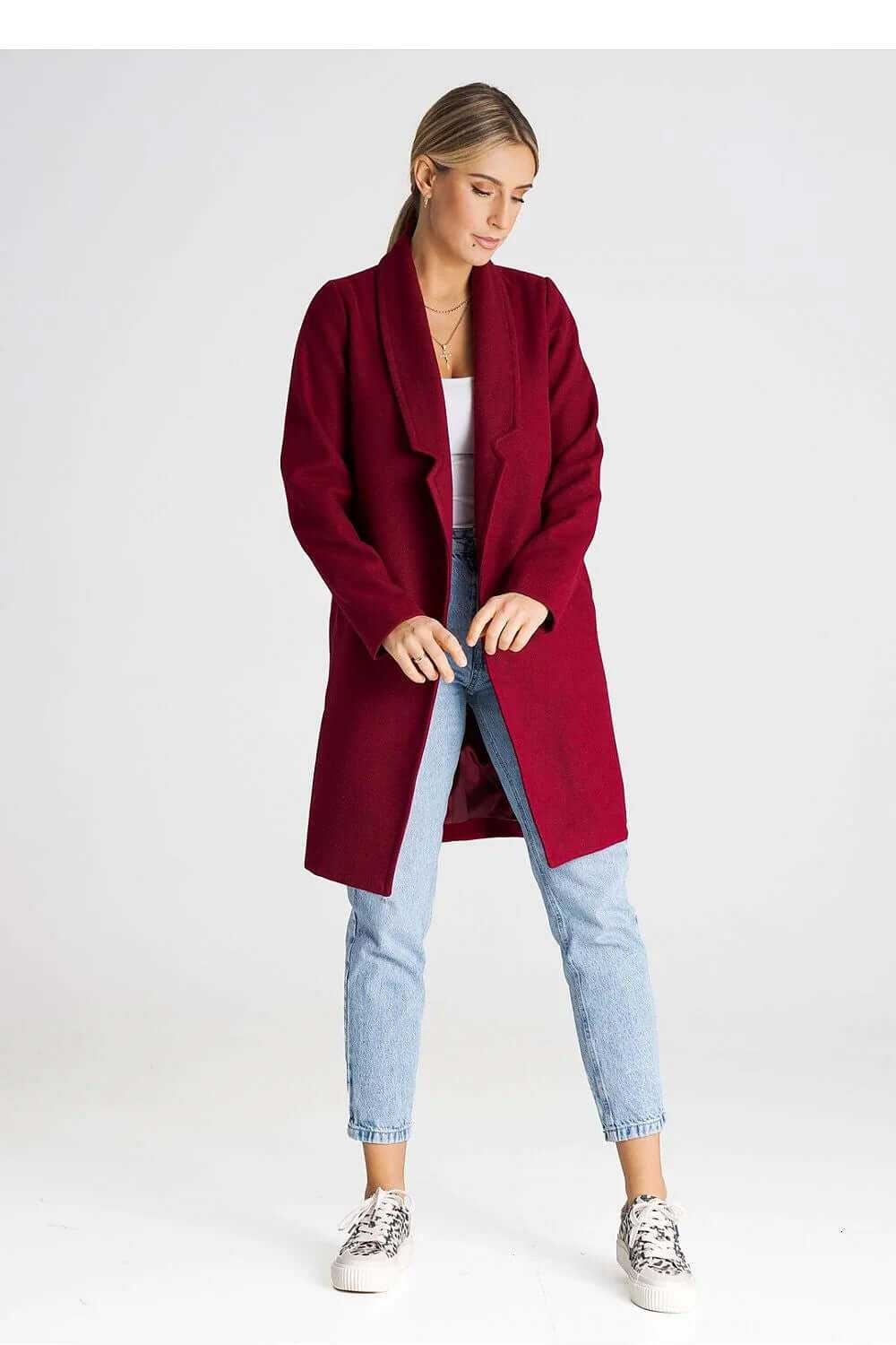 Figl Women’s Longline Winter Coat in burgundy, styled with jeans and sneakers, showcasing its large collar and unbuttoned look.