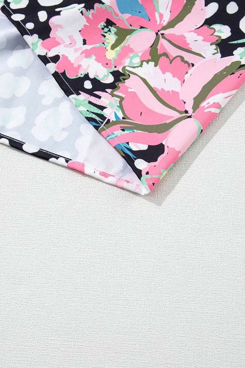 Close-up of floral print fabric showcasing vibrant pink and green flowers on a black background, ideal for a playful dress.
